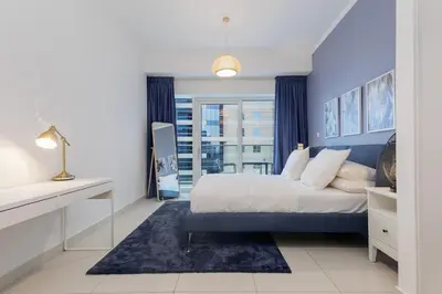 a bedroom with a king sized bed and a window at Sea View, Easy Access, Close to All Amenities in Dubai