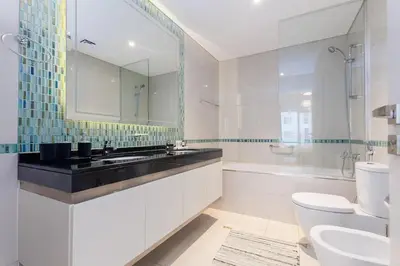 a bathroom with a sink and a toilet and a mirror at Sea View, Easy Access, Close to All Amenities in Dubai