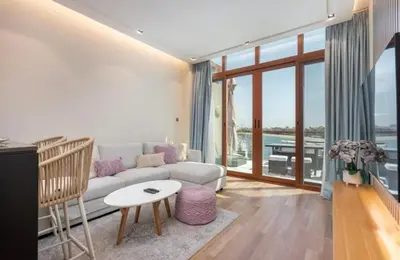 a living room with a couch and a table at The Pretty Pad on The Palm! in Dubai