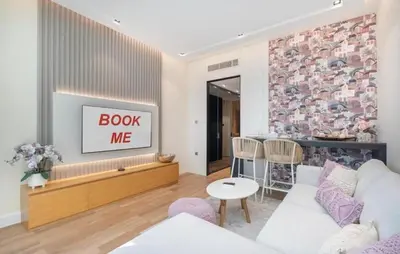 a living room with a couch and a tv at The Pretty Pad on The Palm! in Dubai