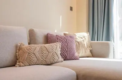 a couch with pillows on it in a living room at The Pretty Pad on The Palm! in Dubai