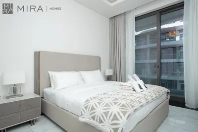 a white bedroom with a bed and a window at Mira Holiday Homes - Newly 2 bedroom with balcony in Business Bay in Dubai