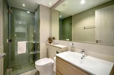 a bathroom with a toilet and a sink and a shower at Stylish 1BR in the heart of Dubai - easy walk by the canal in Dubai