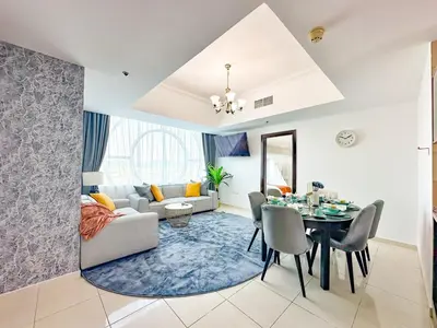 a living room with a table and a dining room at Amazing 2 Bedroom in Al Rabia Tower in Majan 6PPL in Dubai