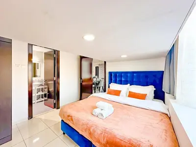 a bedroom with a large bed with a blue headboard at Amazing 2 Bedroom in Al Rabia Tower in Majan 6PPL in Dubai