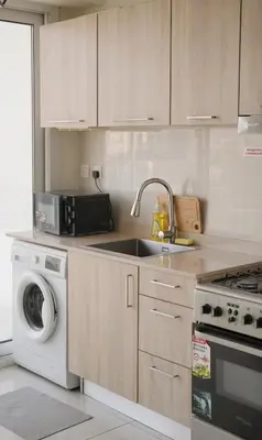 a kitchen with a sink and a washing machine at CaiCai Homes AG Tower-Business Bay in Dubai
