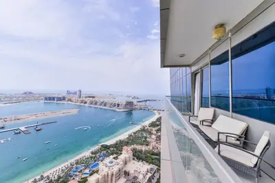a balcony with chairs and a view of the ocean at Luxury Sea View apartment in Dubai