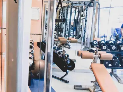 a gym with rows of dumbbells and other equipment at Luxury Sea View apartment in Dubai