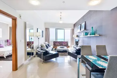 a living room with a person sitting on a couch at Luxury Sea View apartment in Dubai