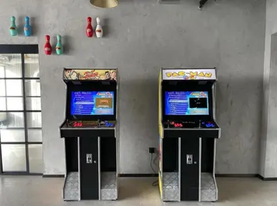 two video game machines sitting next to each other at Elegant 2BR Living Steps from Dubai Hills Park in Dubai