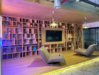 a living room with two chairs and a television at Elegant 2BR Living Steps from Dubai Hills Park in Dubai