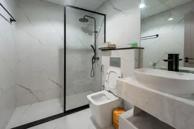 a bathroom with a shower and a toilet and a sink at Dubai Marina - 1BHK Homely Apartment in Dubai