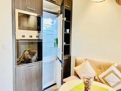 a living room with a couch and an oven at Spacious Spectacular Skyline View in Heart of Dubai in Dubai