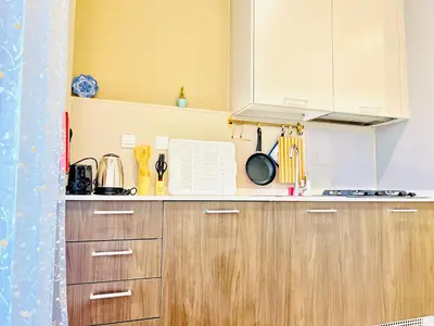 a kitchen with wooden cabinets and a counter top at Spacious Spectacular Skyline View in Heart of Dubai in Dubai