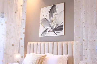 a bedroom with a bed with a picture on the wall at Spacious Spectacular Skyline View in Heart of Dubai in Dubai