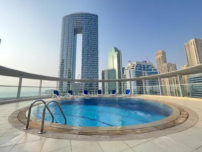 a swimming pool on the roof of a building at 2 Bedroom Apartment with Spacious Private Garden in Dubai Marina in Dubai