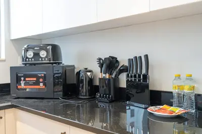 a kitchen with a counter top with a coffee maker at StayShort - Bright and Airy 1-Bedroom Apartment Perfect for 4 in Dubai Marina in Dubai