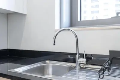 a stainless steel sink in a kitchen with a window at StayShort - Bright and Airy 1-Bedroom Apartment Perfect for 4 in Dubai Marina in Dubai