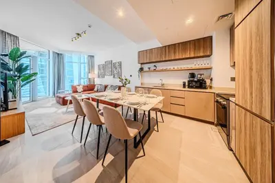 a kitchen and dining room with a table and chairs at 2BR apartment in Missoni in Dubai