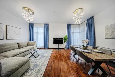 a living room with a couch and a table at Amazing 1BR apartment near metro station in JLT in Dubai