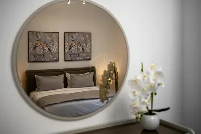 a bedroom with a bed and a mirror on a table at Amazing 1BR apartment near metro station in JLT in Dubai