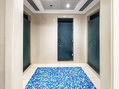 a room with a blue and white tile floor and doors at Amazing 1BR apartment near metro station in JLT in Dubai