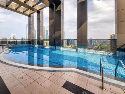 a swimming pool on the roof of a building at Amazing 1BR apartment near metro station in JLT in Dubai