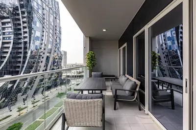 a balcony with a table and chairs and a view of a city at stylish 2 bedroom Apt in Business bay Dubai in Dubai