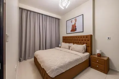 a bedroom with a large bed and a window at stylish 2 bedroom Apt in Business bay Dubai in Dubai