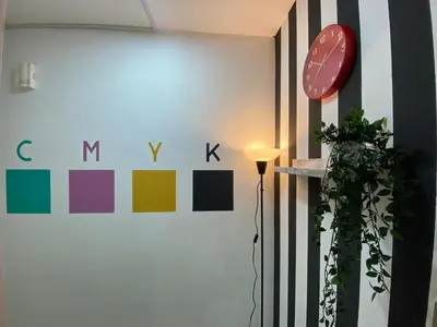 a room with a wall with a clock and a plant at Partition Room with window In Barsha Near Metro in Dubai