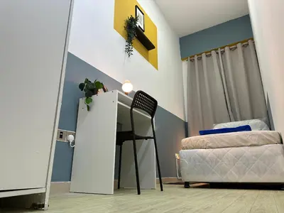 a bedroom with a mirror and a bed and a desk at Partition Room with window In Barsha Near Metro in Dubai