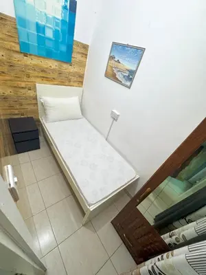 a white bench in a room with a picture on the wall at Cool valley homes in Dubai