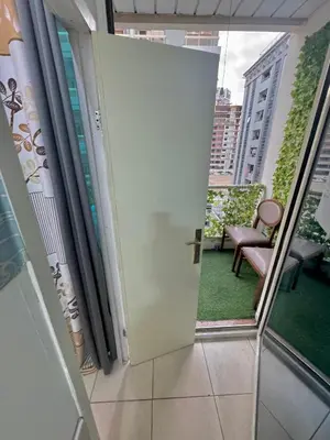 an open door to a balcony with a chair at Cool valley homes in Dubai