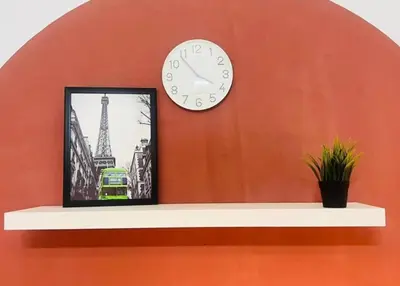 a clock on a wall with a picture of the eiffel tower at Niche Double Partition Room in Tecom Near Metro in Dubai