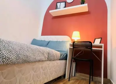 a bedroom with a bed and a desk with a chair at Niche Double Partition Room in Tecom Near Metro in Dubai