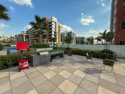a patio with two chairs and a red sign in a city at Luxuriöser Aufenthalt mit Blick auf den Burj Khalifa in Dubai