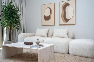 a living room with a white couch and a coffee table at Modern 1-Bedroom Retreat in MBR City in Dubai