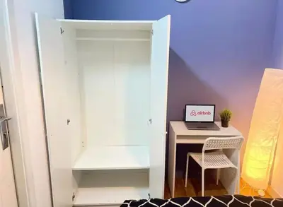 a room with a desk and a laptop on a table at Twin Bed Partition Room Near ICM Metro in Dubai