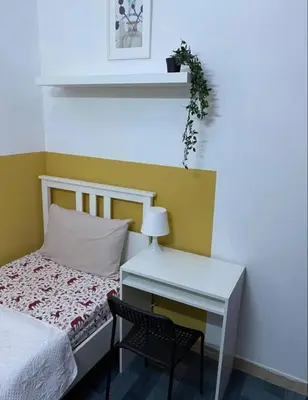 a bedroom with a bed and a desk with a chair at City Stay Partition Room in al Barsha 1 Near Metro in Dubai
