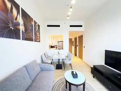 a living room with a couch and a table at Luxurious new 1 bedroom with Balcony and New Building in Dubai