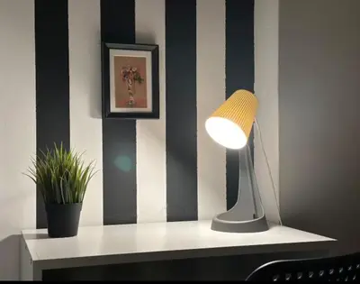 a desk with a lamp and a plant on it at Double Bed Partition Room Near Mashreq Metro in Dubai