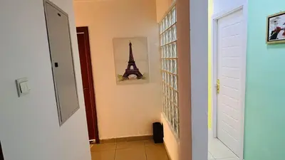 a hallway with a room with a picture of the eiffel tower at Bagpack Double Partition Room in Tecom Near Metro in Dubai