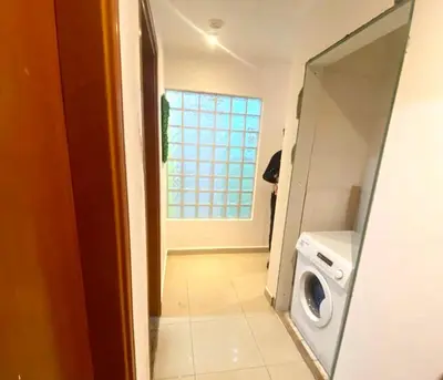 a laundry room with a washing machine and a window at Bagpack Double Partition Room in Tecom Near Metro in Dubai