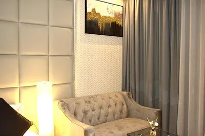 a living room with a couch and a table at Luxuriously Designed Spacious Studio In JVC in Dubai
