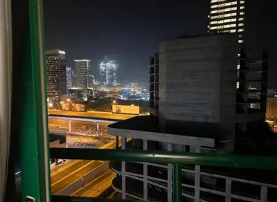 a view of a city skyline at night at Adventurers Partition Room in Barsha Heights in Dubai