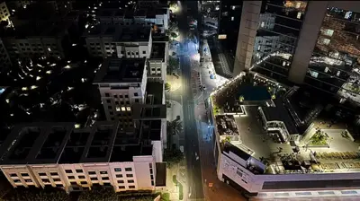 an aerial view of a city at night at Adventurers Partition Room in Barsha Heights in Dubai