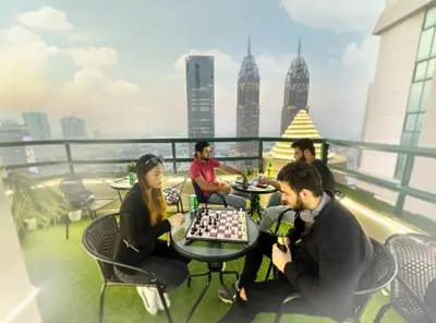 a group of people playing chess on the roof of a building at Adventurers Partition Room in Barsha Heights in Dubai