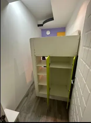 a small room with a book shelf in a hallway at Loft Room in Al Barsha 1 Near MOE Metro in Dubai