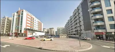 a city intersection with cars on a street with buildings at Compact Partition Room in Barsha in Dubai