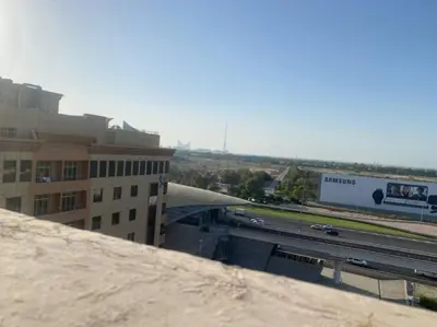 a view of a city with a highway and a building at Newly Furnished Room in Barsha 1 Near MOE in Dubai